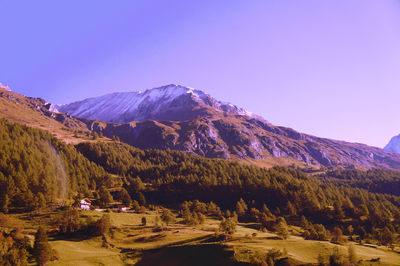 Scenic view of mountains against clear blue sky