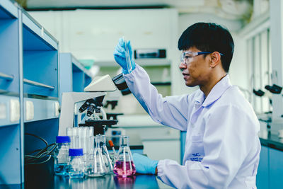 Side view of young man working at laboratory