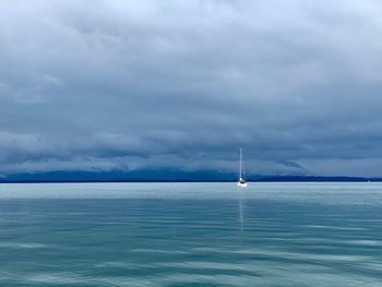 Sailboat in sea against sky