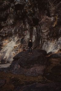 Man on rock in cave