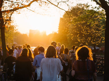 People standing at public park during sunset