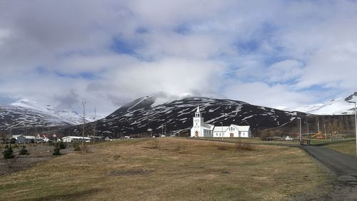 Scenic view of snowcapped field against sky