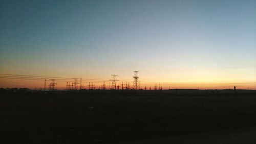 Silhouette landscape against clear sky at sunset