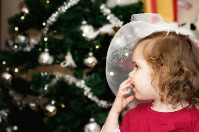 Girl against christmas tree