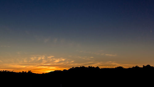 Silhouette landscape against scenic sky