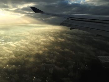 Aerial view of airplane flying over city