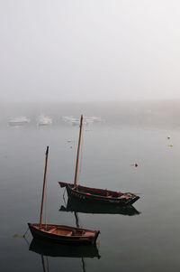 Ship moored in lake against sky