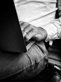 Midsection of man using laptop