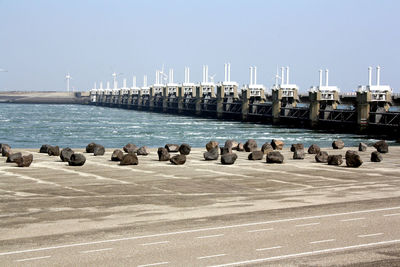 Flock of pier on sea against clear sky