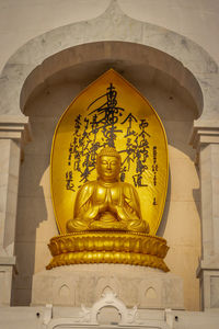 Low angle view of statue against building