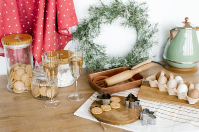 Kitchen utensils. christmas wreath, teapot, chicken eggs, champagne glasses, wooden rolling pins