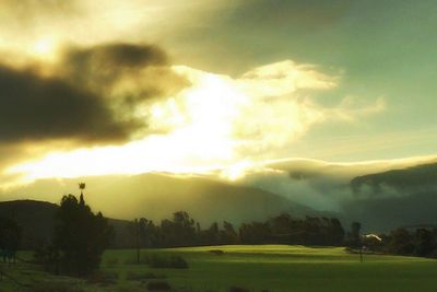 Scenic view of landscape against storm clouds