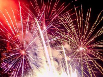 Low angle view of firework display at night