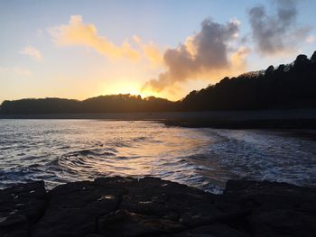 Scenic view of lake against sky during sunset