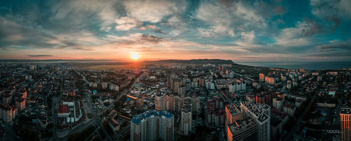 High angle view of illuminated buildings against sky during sunset