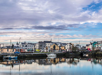 View of harbor against cloudy sky