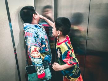 Boy standing against wall