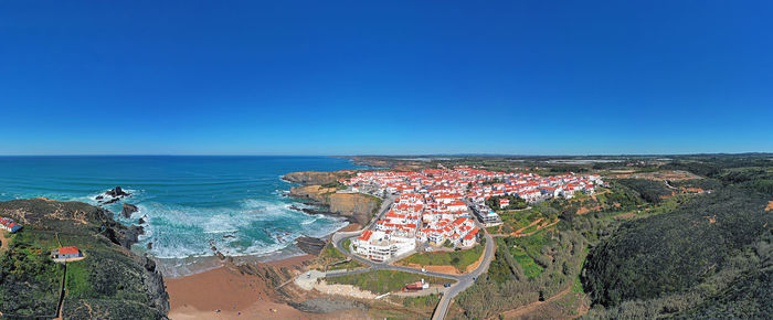 High angle view of sea against clear blue sky