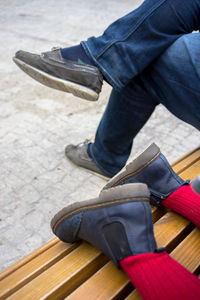 Low section of man standing on tiled floor
