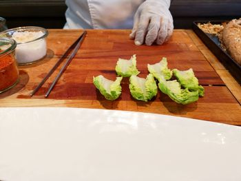 Midsection of person preparing food on table