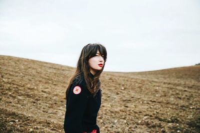 Portrait of young woman standing