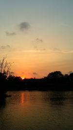 Scenic view of lake against romantic sky at sunset