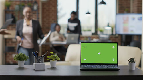 Laptop with green display on table