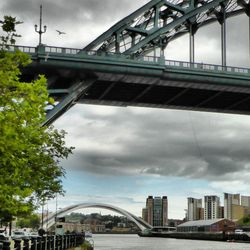 Bridge over river against cloudy sky