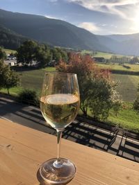 Wineglass on table against mountains