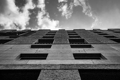 Low angle view of building against cloudy sky