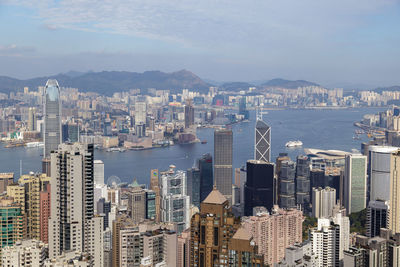 High angle view of city by sea against sky