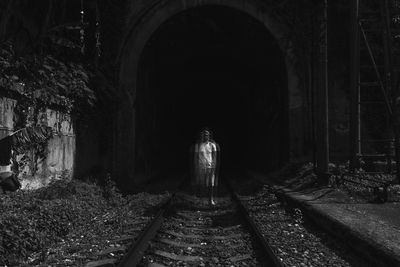Rear view of man standing in tunnel