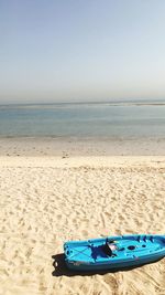 Deck chairs on beach against sea