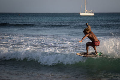 Full length of boy on sea against sky