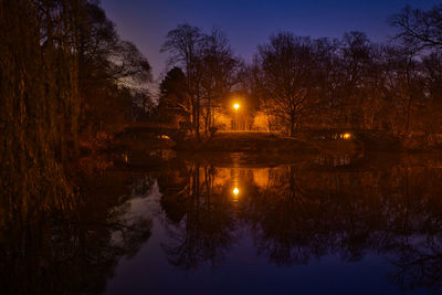 Scenic view of lake against sky at night