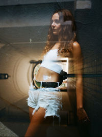 Double exposure image of woman standing in building at night