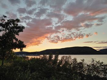 Scenic view of lake against orange sky