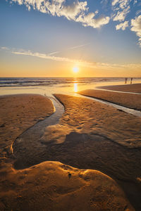 Atlantic ocean sunset with surging waves at fonte da telha beach, portugal