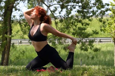 Woman practicing yoga at park