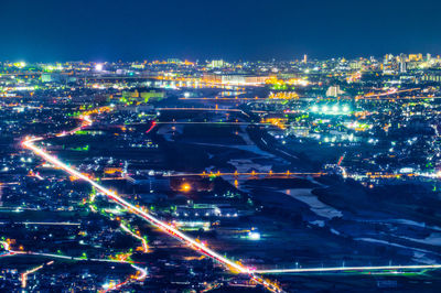 High angle view of illuminated city buildings at night