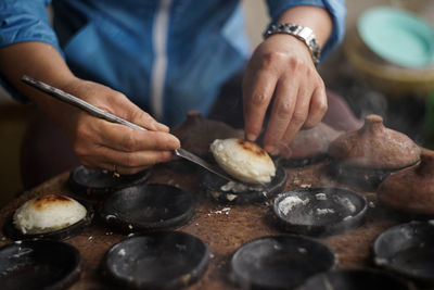 Midsection of man preparing food