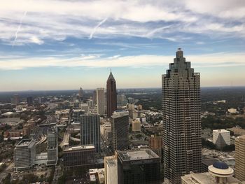 View of cityscape against cloudy sky