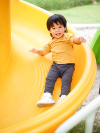 Portrait of cute girl sitting on slide