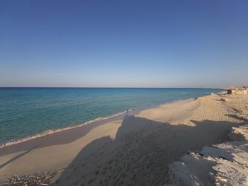 Scenic view of beach against clear sky