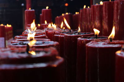 Close-up of lit candles in temple