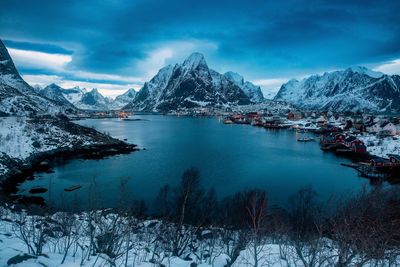 Scenic view of snowcapped mountains against sky in reine, norway