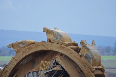 Low angle view of old sculpture against clear sky