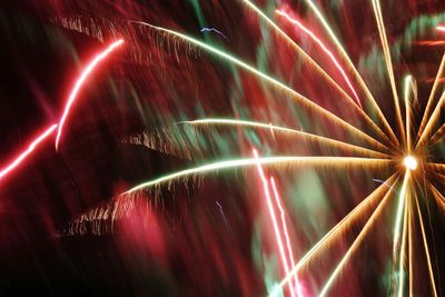 Low angle view of illuminated fireworks at night