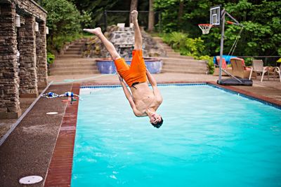 Man jumping in swimming pool