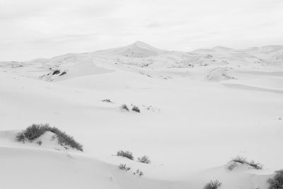 Scenic view of snow covered mountains against sky